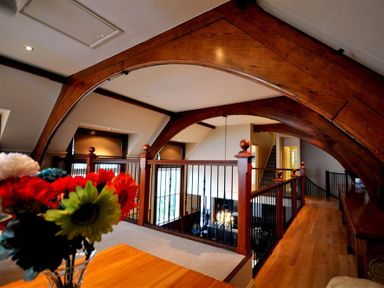 An indoor loft area with wooden beams and railings overlooking a lower floor at The Old Portland Courthouse in Portland