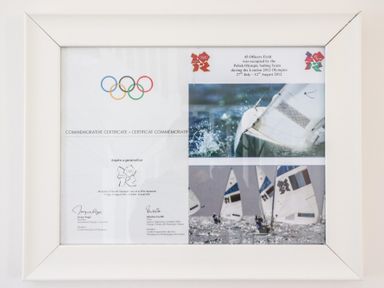 Framed commemorative certificate with olympic rings and sailing images at Osprey House Portland