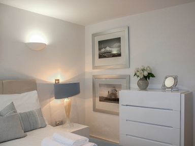 A bedroom with a bed and lamp at Estuary View in Kingsbridge