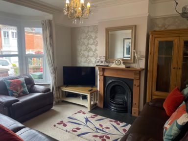 A living room with a television and sofa at Pedaller's Cottage in Weymouth