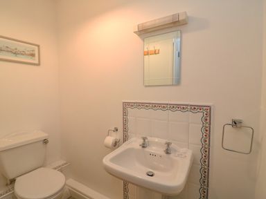A bathroom with a toilet and a sink with a mirror above at Reaver Brewers Quay harbour