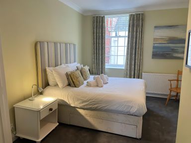 A bedroom with a bed and window at Safe Harbour in Brewers Quay harbour