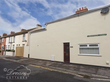 A row of houses on a street with a visible door and window on brownlow street at Sunny Days in Weymouth