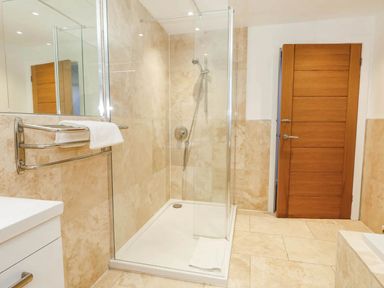 A bathroom featuring a shower and towel rack at Tides Corner Bowleaze