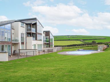 A view of buildings and a swimming pool in the outdoor area at 2 Ocean's Edge Thurlestone