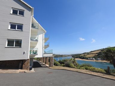 A building with balconies overlooking a river and hills at 2 Poundstone Court in Salcombe
