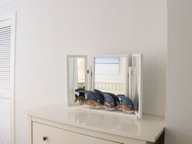A mirror and decorative fish on a dresser at 2 Poundstone Court Salcombe