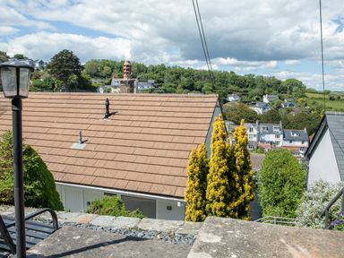 A view of rooftops trees and houses in a residential area with a lamp post in the foreground at 2 Rockmount in Salcombe