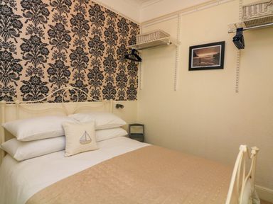 A bedroom with a bed and shelving at 3 Dartview in Dartmouth
