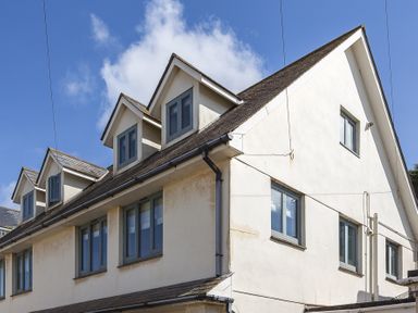 Exterior view of a multi-story house with dormer windows and gray framed windows at 4 Armada House Hope Cove