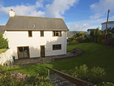 A two-story house with a garden and paved patio in Amberley Dartmouth