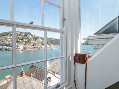 A window with a view of rooftops water and houses on a hill at Kings View in Dartmouth