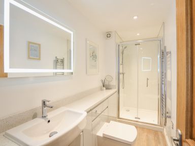 A bathroom with a sink toilet and shower enclosure at Kings View in Dartmouth