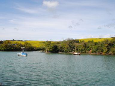 A river with boats and green hills in the background at Orchard Barn in Salcombe