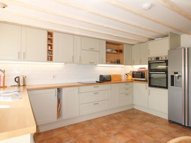 A kitchen with a sink and appliances at Orchard Barn Salcombe