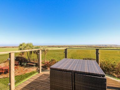 An outdoor area with a table and views of a field at The Station in Bolberry