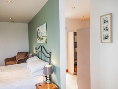 A bedroom with a bed and an armchair at The Station in Bolberry