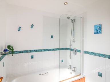 A bathroom with a bathtub and shower at The Station in Bolberry