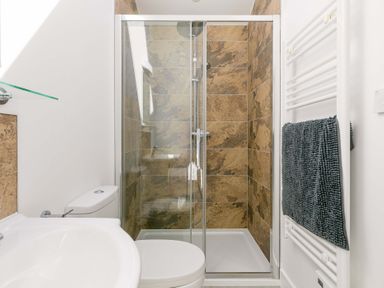 A bathroom with a shower and toilet at Mellydonen Beder Del (Melly), Tor Down Quarry St Breward