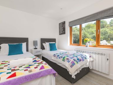 A bedroom with two beds at Mellydonen Beder Del (Melly), Tor Down Quarry in St Breward