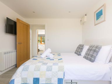 A bedroom with a bed and television at Mellydonen Beder Del (Melly), Tor Down Quarry, St Breward