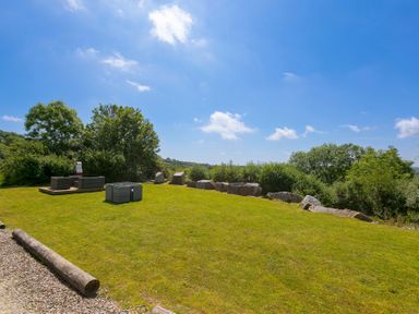 A garden with seating and rocks at Mellydonen Beder Del (Melly), Tor Down Quarry in St Breward