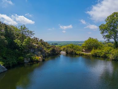A garden with a pond and deck at Mellydonen Beder Del (Melly), Tor Down Quarry, St Breward