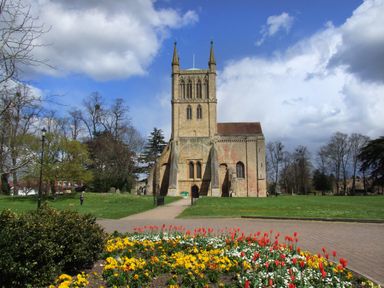 A church with a tower in a park with flower beds and pathways at The Hideaway in Eckington