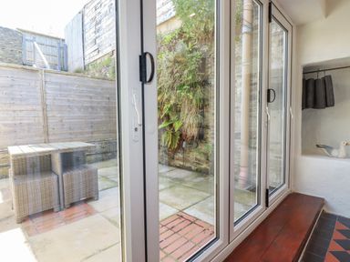 A snug with a glass door opening to a garden at Rock House Trebarwith Strand near Tintagel