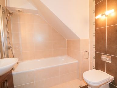 A bathroom with a bathtub shower toilet and sink at Ullswater 29 in Penrith
