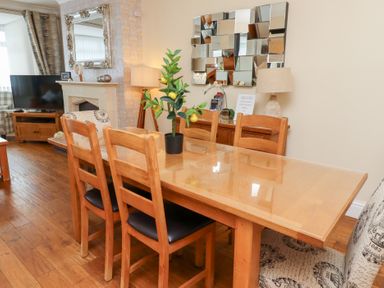 A dining room with a table and chairs at Beach Cove View in Newbiggin-by-the-Sea