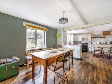 A kitchen with a dining table and chairs at Spring Park Farmhouse in Launceston