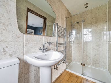A bathroom with a shower and sink at Spring Park Farmhouse in Launceston