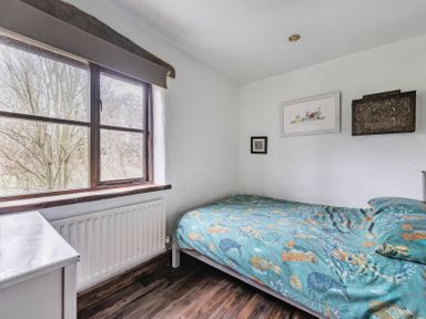 A bedroom with a bed and window at Spring Park Farmhouse in Launceston