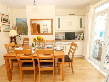 A dining room with a table set for dinner at 32 Cranleigh Close Tuckton