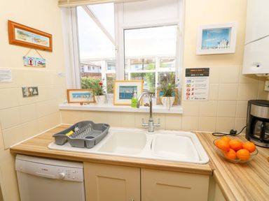 A kitchen with a sink and dishwasher at 32 Cranleigh Close Tuckton