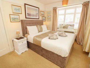 A bedroom with a bed and bedside table at 32 Cranleigh Close Tuckton