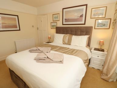 A bedroom with a bed and bedside table at 32 Cranleigh Close in Tuckton