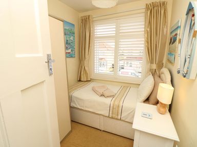 A bedroom with a single bed and nightstand at 32 Cranleigh Close Tuckton