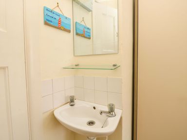A bathroom with a sink and mirror at 32 Cranleigh Close Tuckton