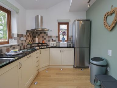 A kitchen with appliances and cabinets at Langtree Arnside