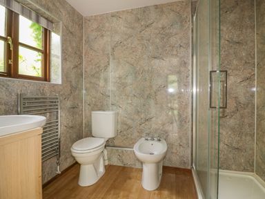 A bathroom with a toilet bidet sink shower and window at Ribby Farmhouse in Lerryn