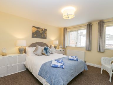 A bedroom with a double bed two bedside lamps and a map on the wall at Valiant House in Scarborough