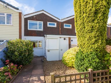 Front exterior of a two story house with a garden path and bushes at 164 Cumber Close in Malborough