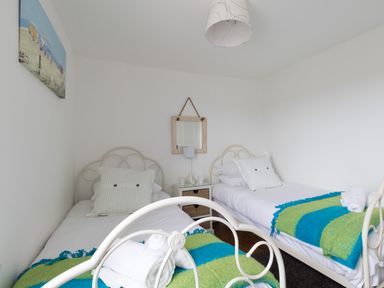 A bedroom with two single beds and a bedside table between them at Fenders Brewers Quay Harbour