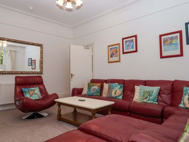 A living room with a sofa and armchair at Babbacombe Hall in Babbacombe