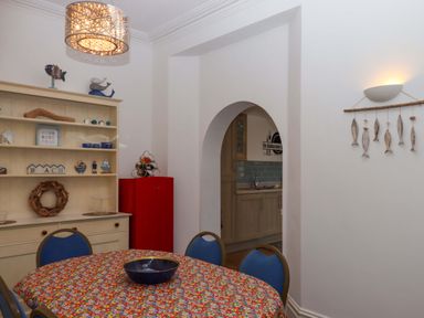 A dining room with a table and chairs at Babbacombe Hall Babbacombe