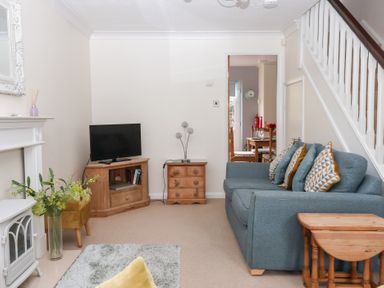 A living room with a sofa and television at 17 Fewster Way in York