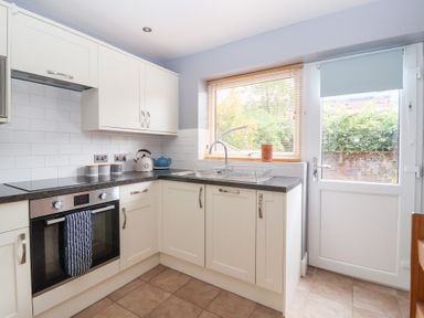 A kitchen with cabinets, sink, and oven at 17 Fewster Way, York