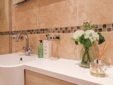 A bathroom sink with faucet and toiletries at 17 Fewster Way in York
